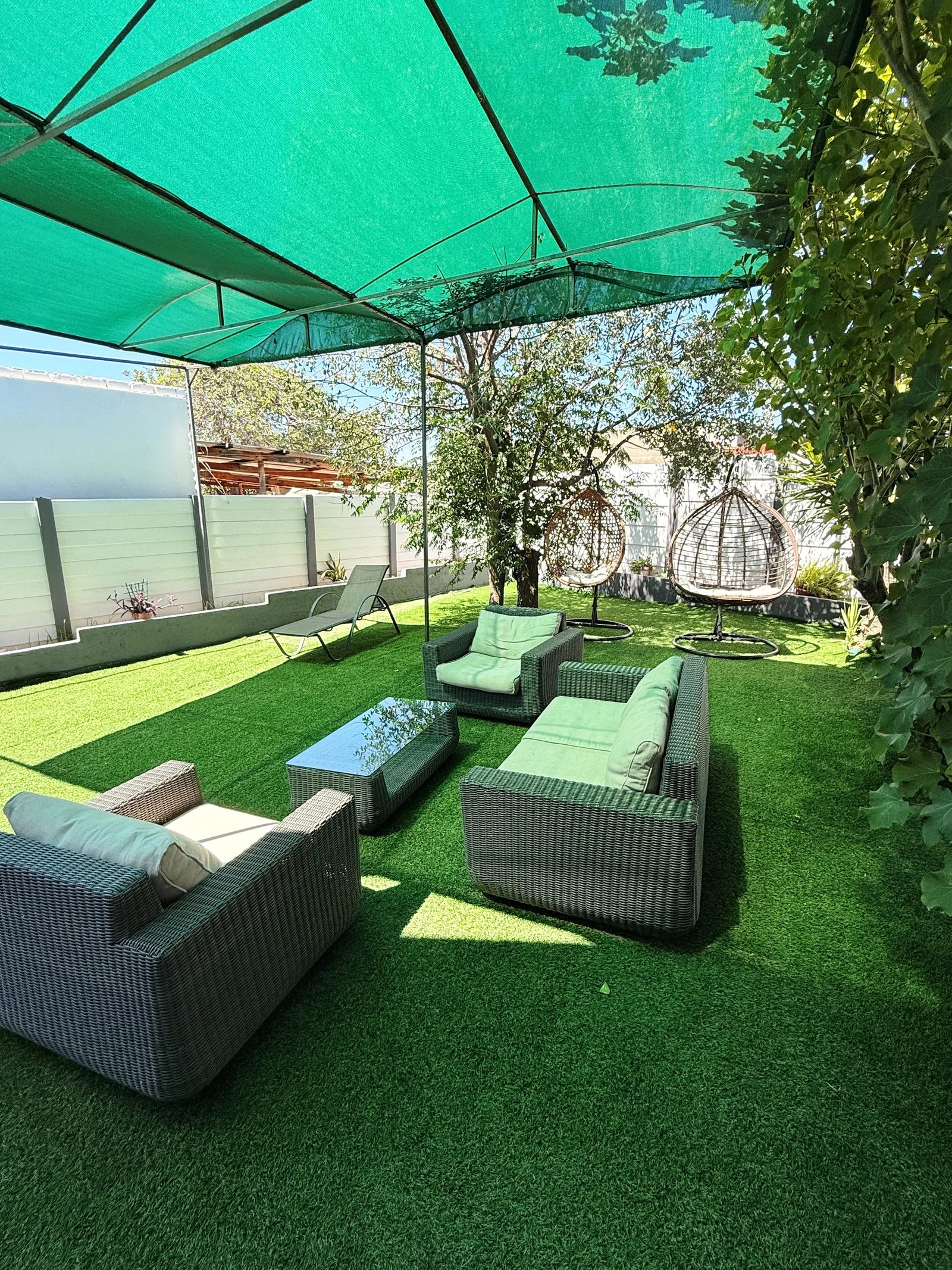 Lounge set under the green shade sail