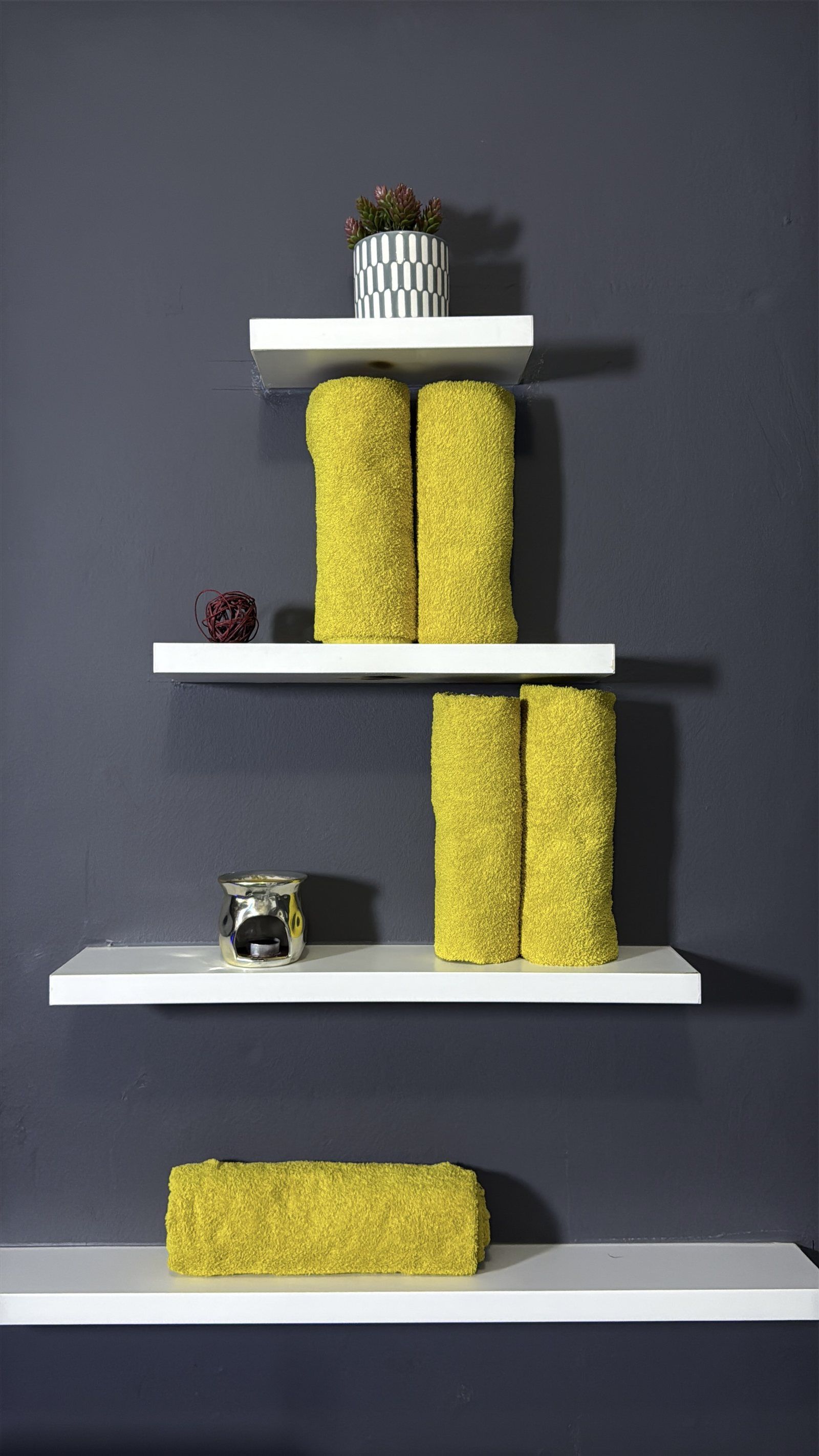 Rolled towels and candles on the shelves