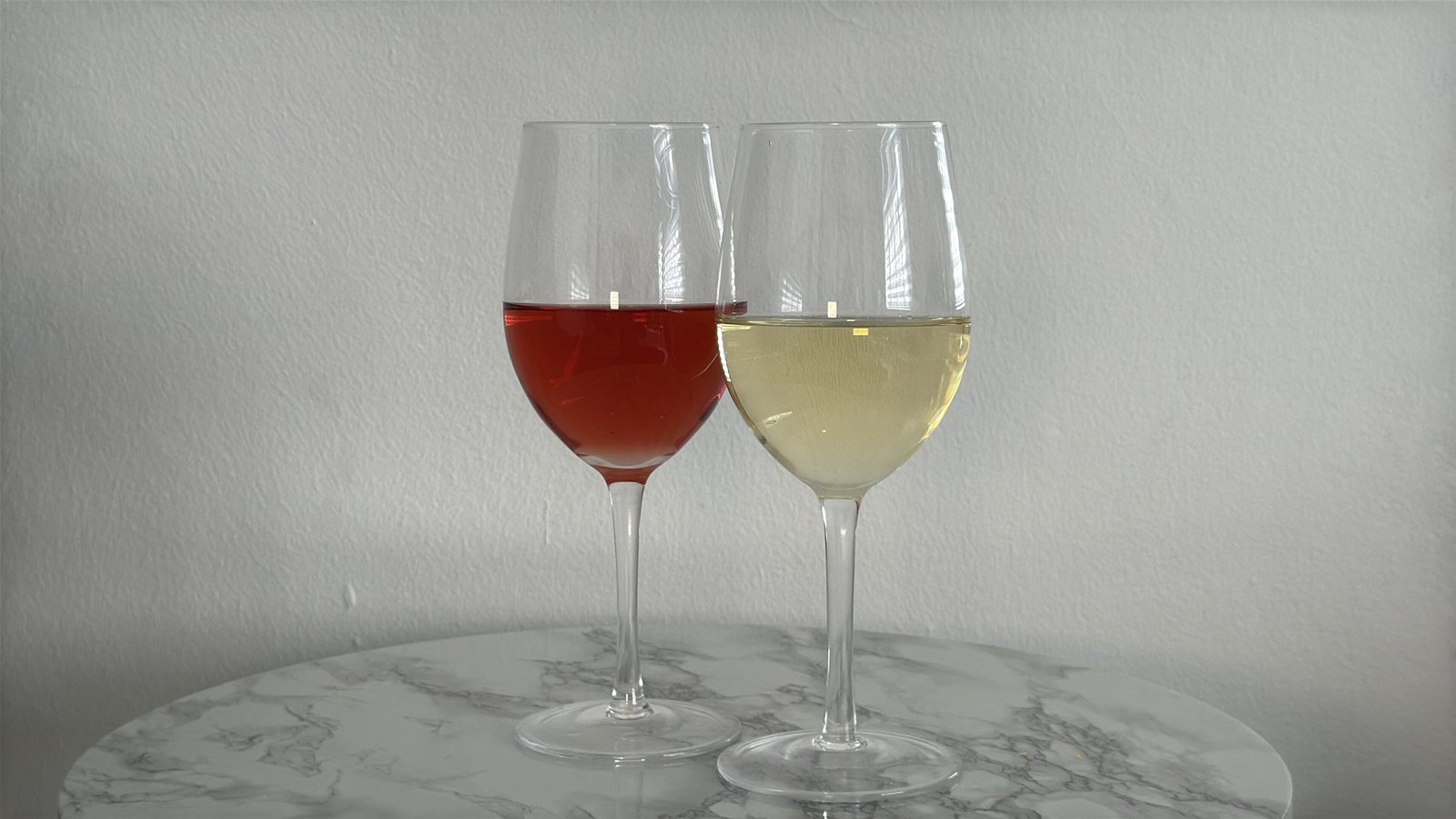 Red and white wine on marble