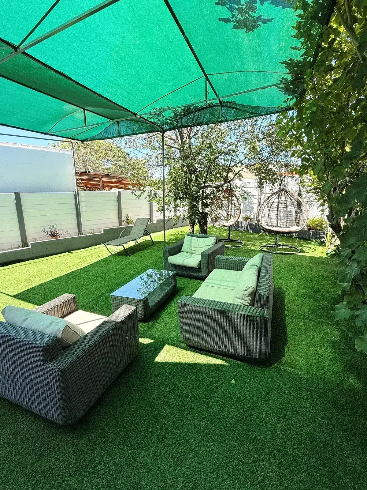 Lounge set under the green shade sail