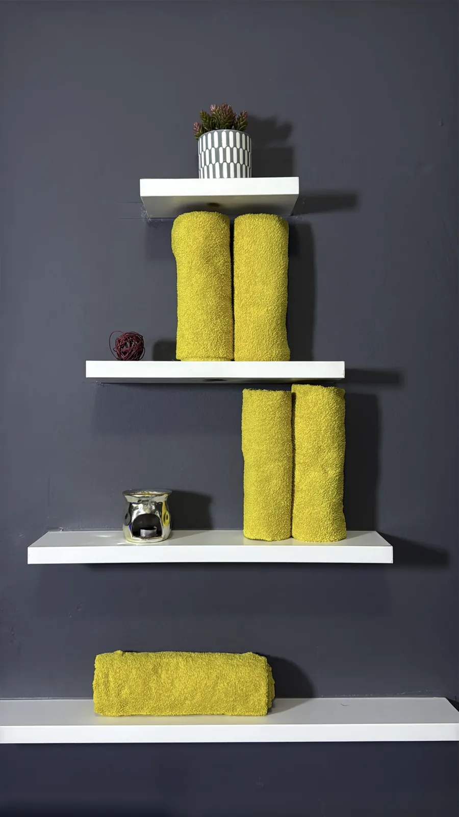 Rolled towels and candles on the shelves